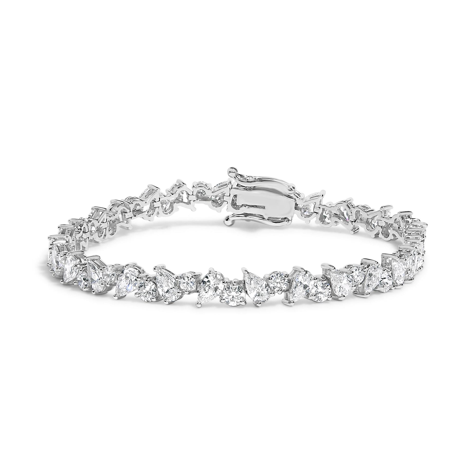 White metal bracelet with alternating pear-shaped and round white gemstones in 3-prong settings, shown from a front angle.
