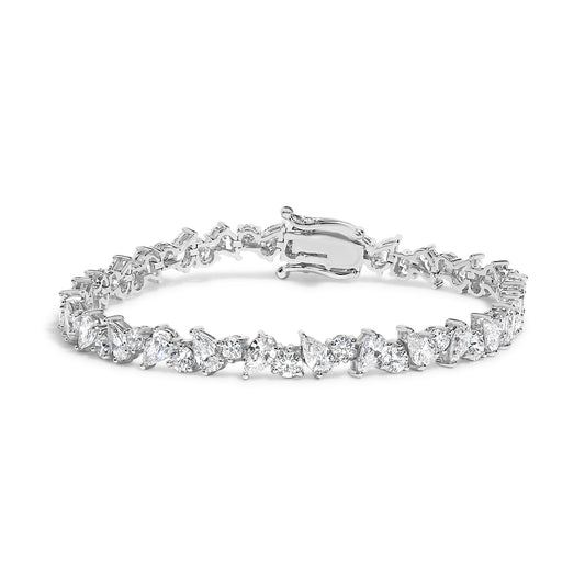 White metal bracelet with alternating pear-shaped and round white gemstones in 3-prong settings, shown from a front angle.