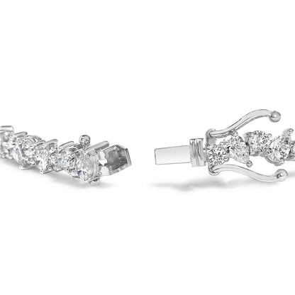 Close-up side angle of a white metal bracelet with alternating pear-shaped and round white gemstones set in three-prong settings, showing the clasp open.