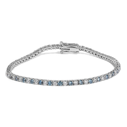 Bracelet with alternating white and blue round gemstones in 4-prong settings on white metal, shown from a slightly elevated front angle.