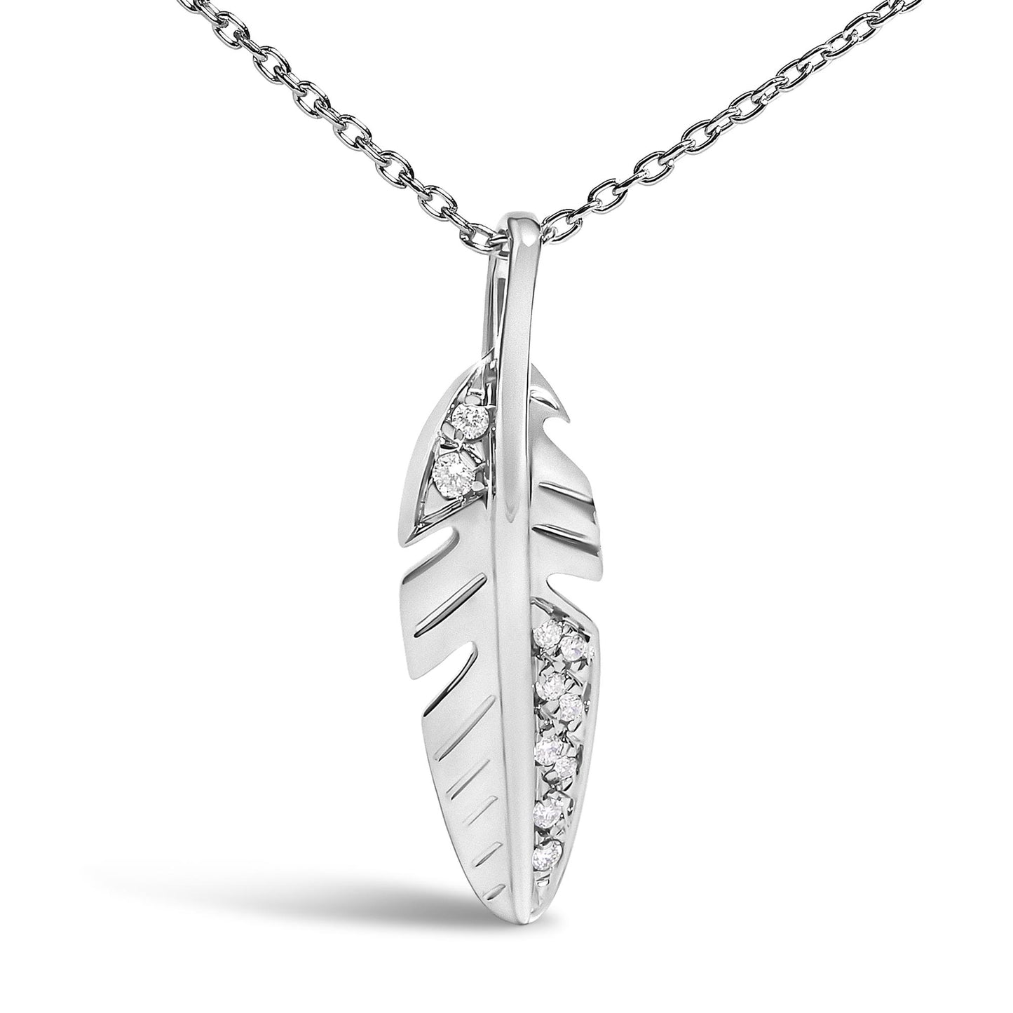 Close-up front view of a white metal feather-shaped necklace pendant with round white gemstones set in pave sections along the feather.