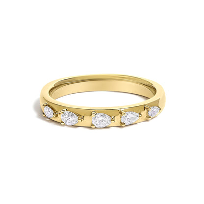 Close-up front angle of a yellow ring with five pear-shaped white gemstones in 3-prong settings on the band.