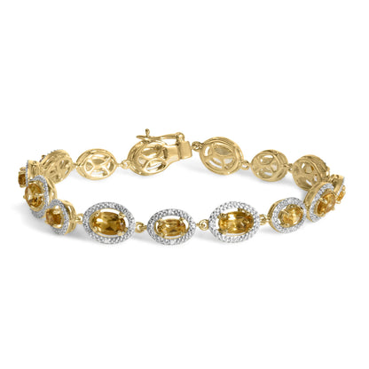 Close-up front view of a yellow metal bracelet with linked oval shapes, each set with yellow oval gemstones surrounded by white gemstones in a pave setting, shown on a white background.