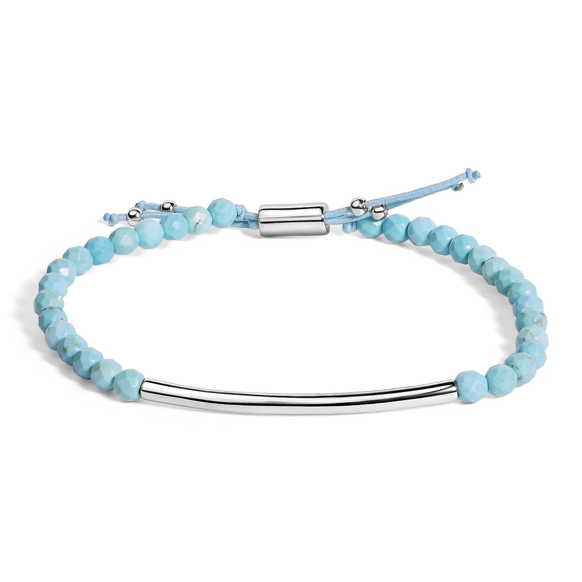 Bracelet with light blue faceted gemstones and a smooth curved white metal bar, shown flat from an overhead angle on a white background.