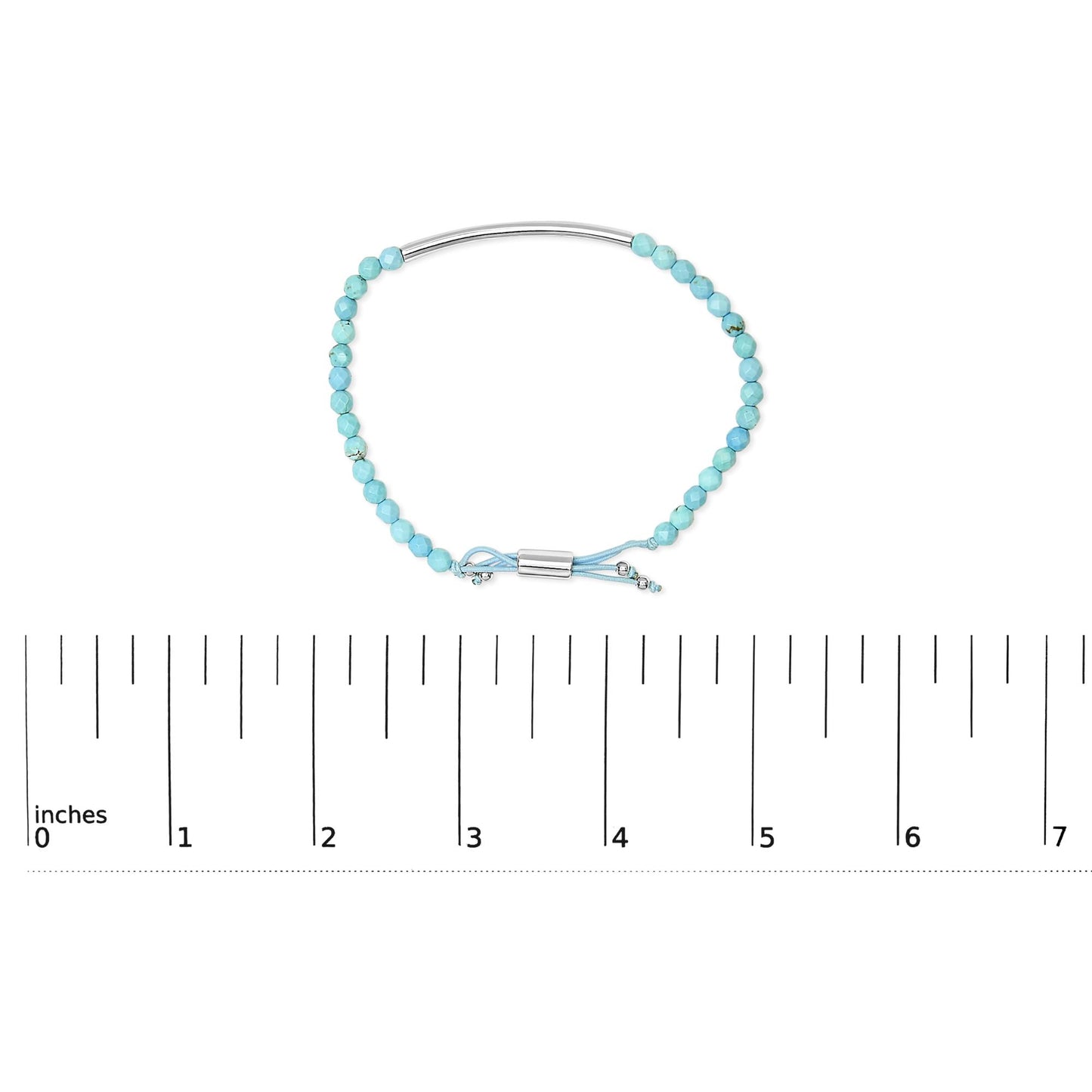 White metal bracelet with faceted blue beads and adjustable cord shown on a scale, top-down angle.