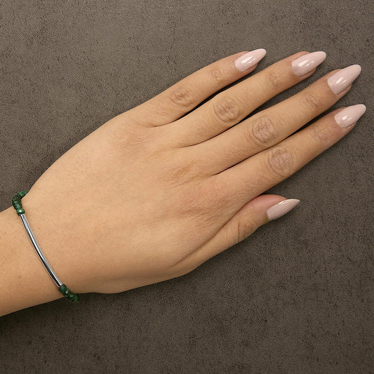 Adjustable sterling silver malachite bolo bracelet worn on wrist
