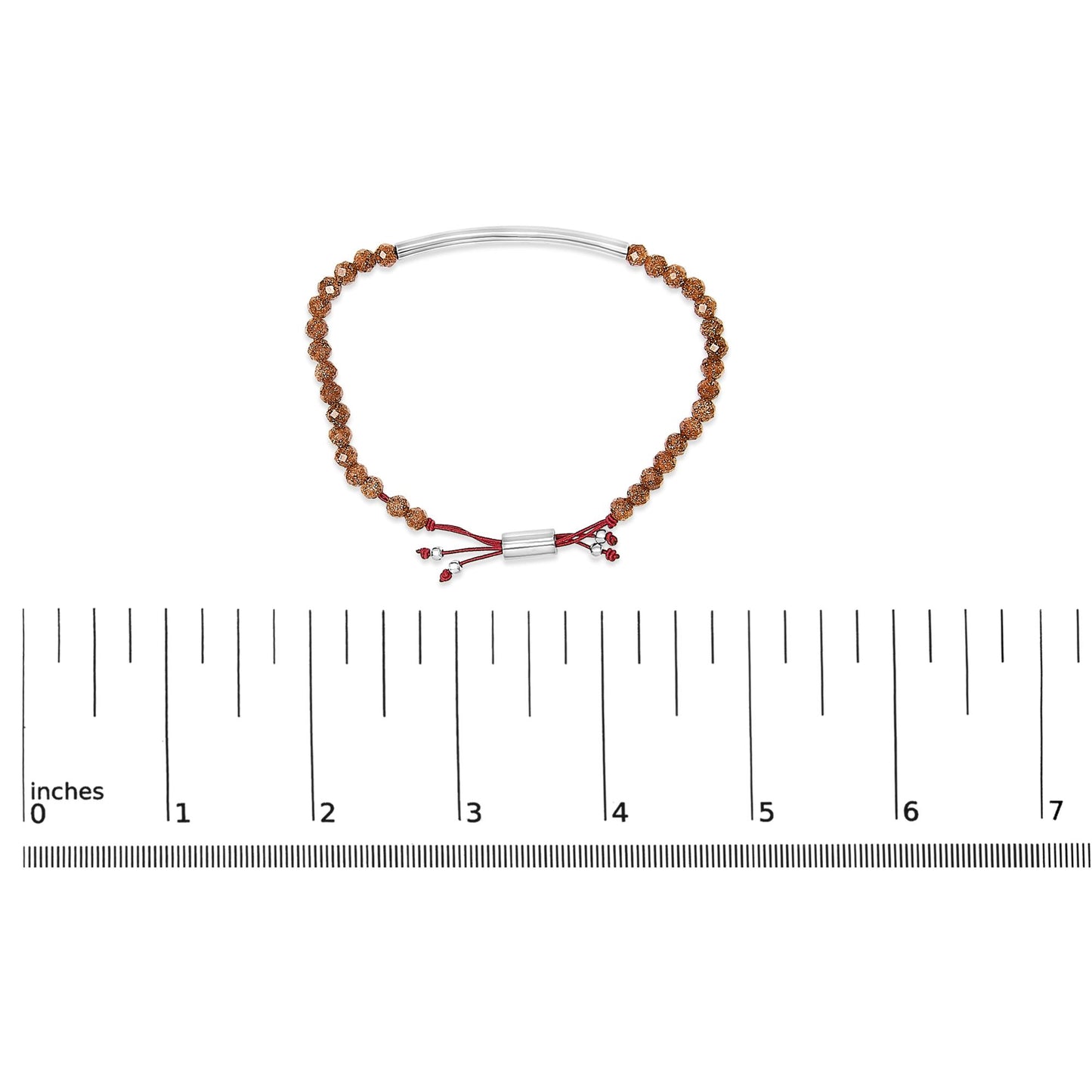 Bracelet with brown textured beads and a white curved bar, red adjustable cord with red and white gemstones, shown on a scale from a top-down angle.