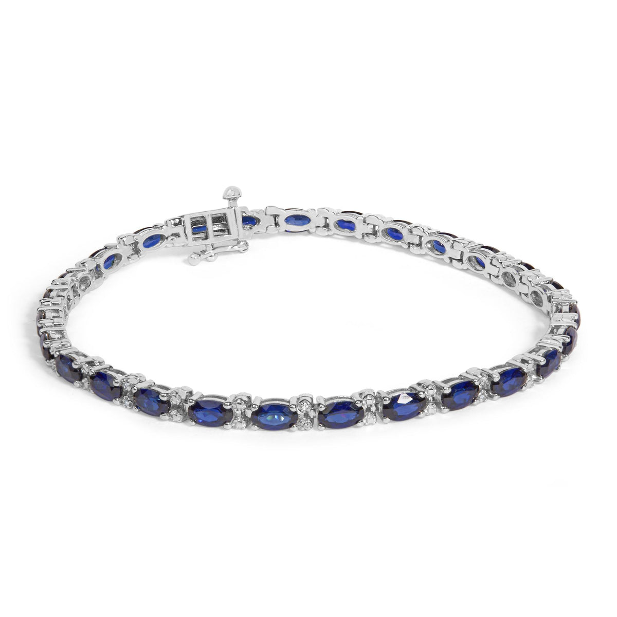 White metal bracelet with oval blue gemstones and round white gemstones in prong settings, shown on a white background with a top-down angle.