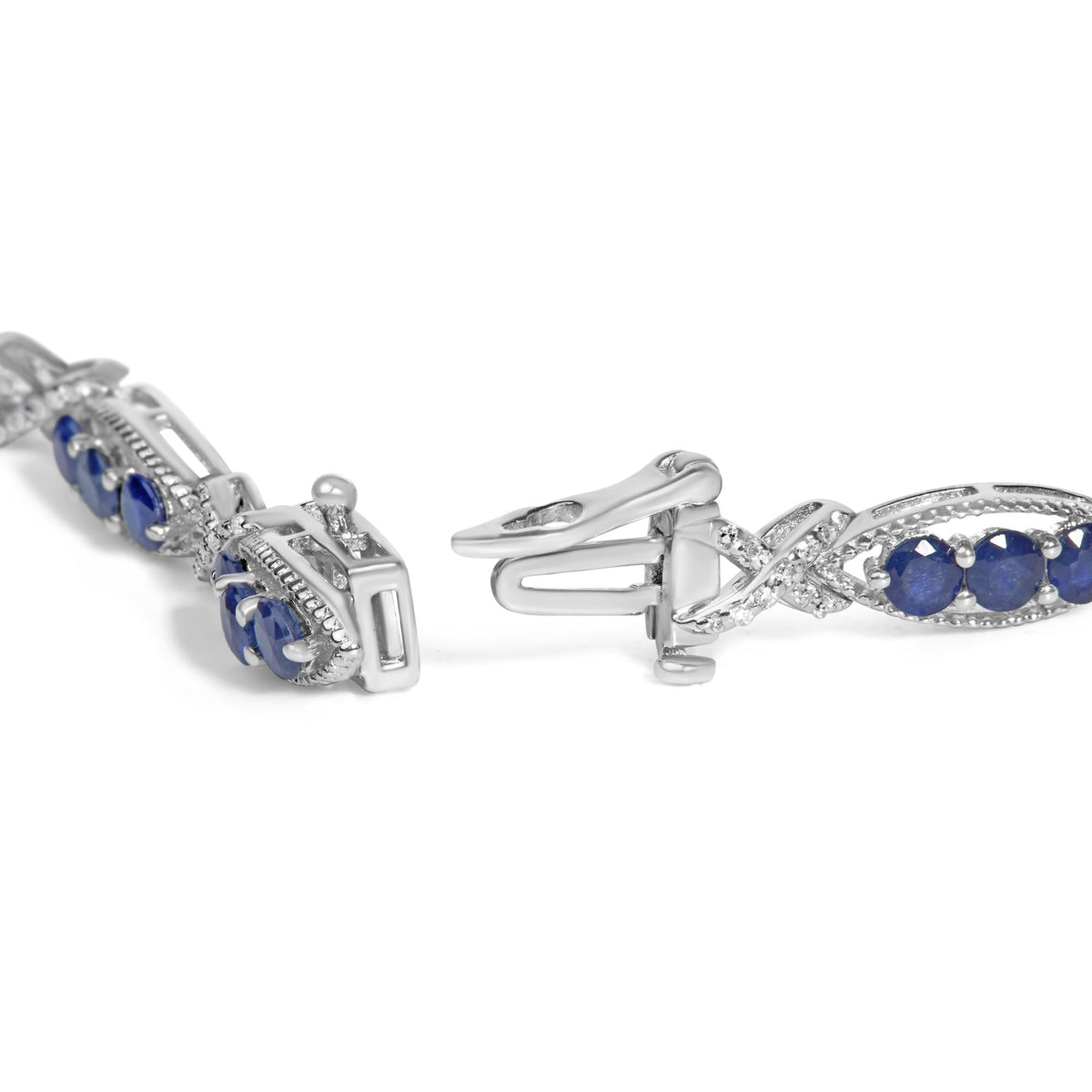 Close-up front angle of a white metal bracelet featuring an alternating pattern of round blue gemstones and white gemstones set with prongs, shown on a white background.