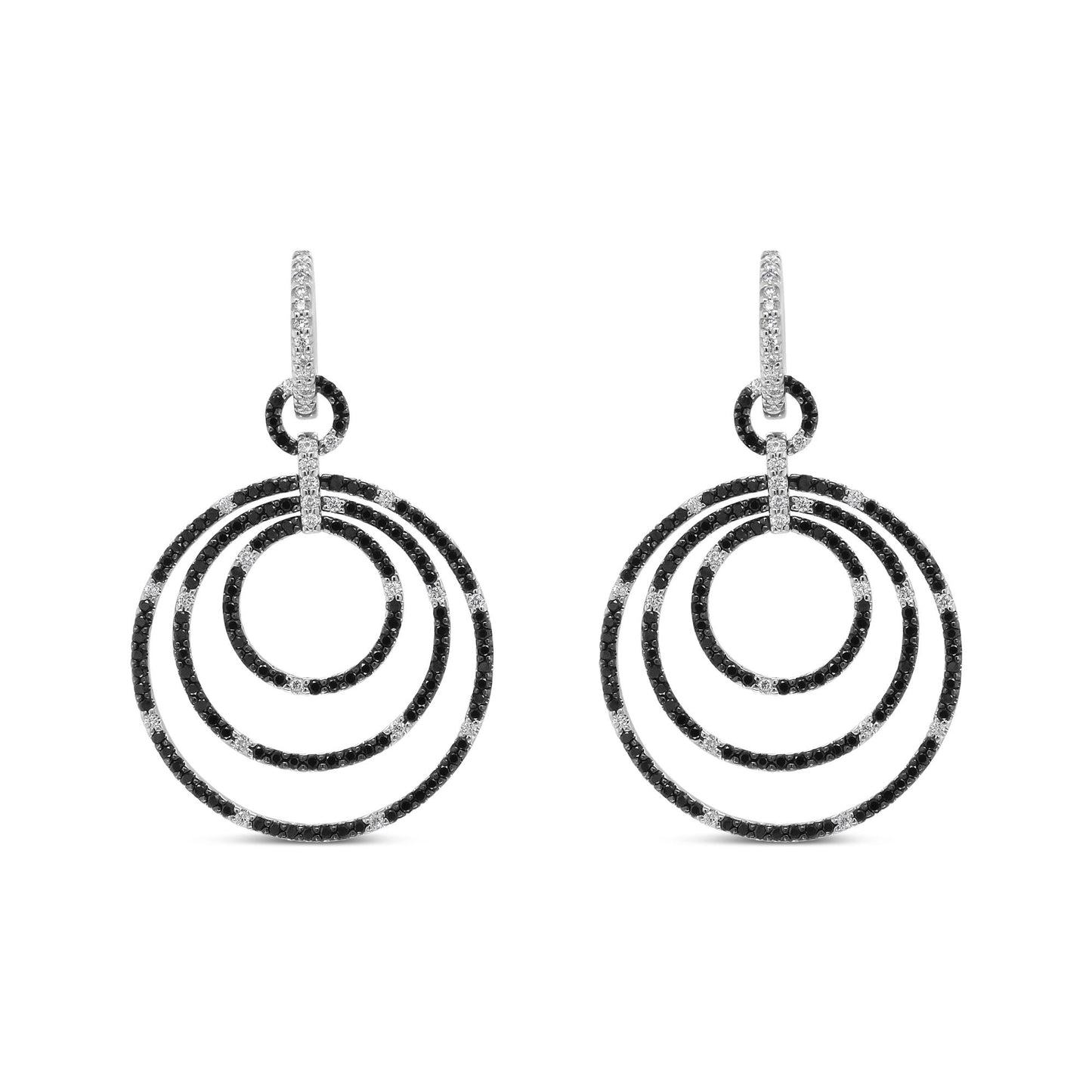Front view of white metal earrings with three concentric hoop shapes adorned with alternating black and white round gemstones in prong settings.