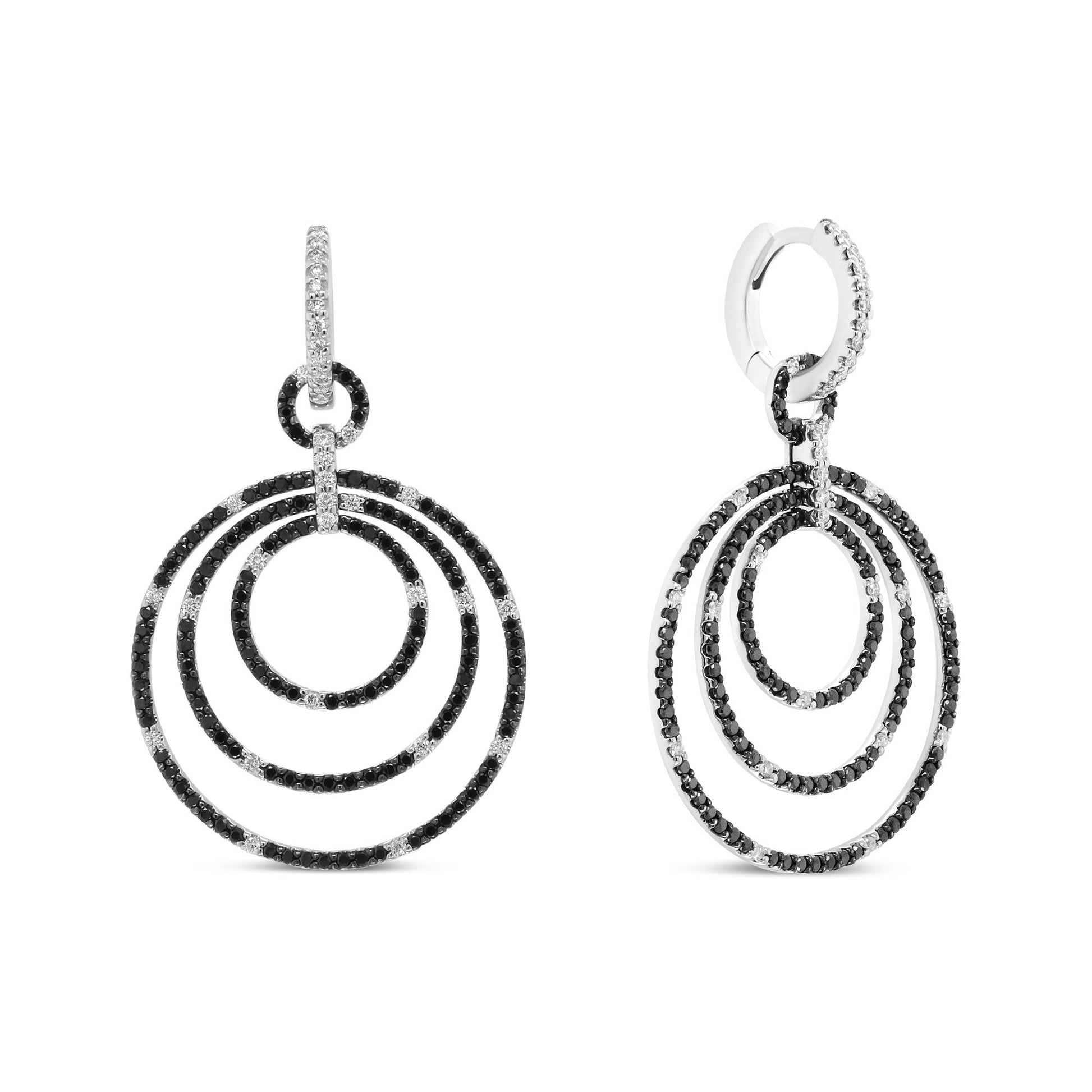 Front and side view of white metal dangle earrings featuring concentric circular hoops adorned with black and white round prong-set gemstones.