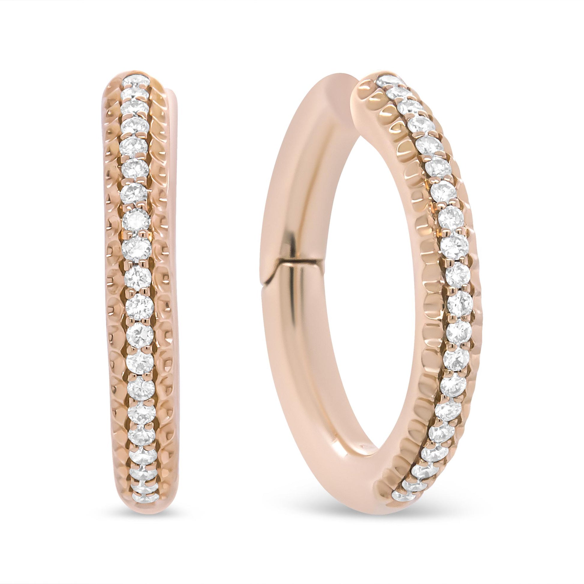 Close-up front and side view of rose metal hoop earrings with a row of prong-set round white gemstones.