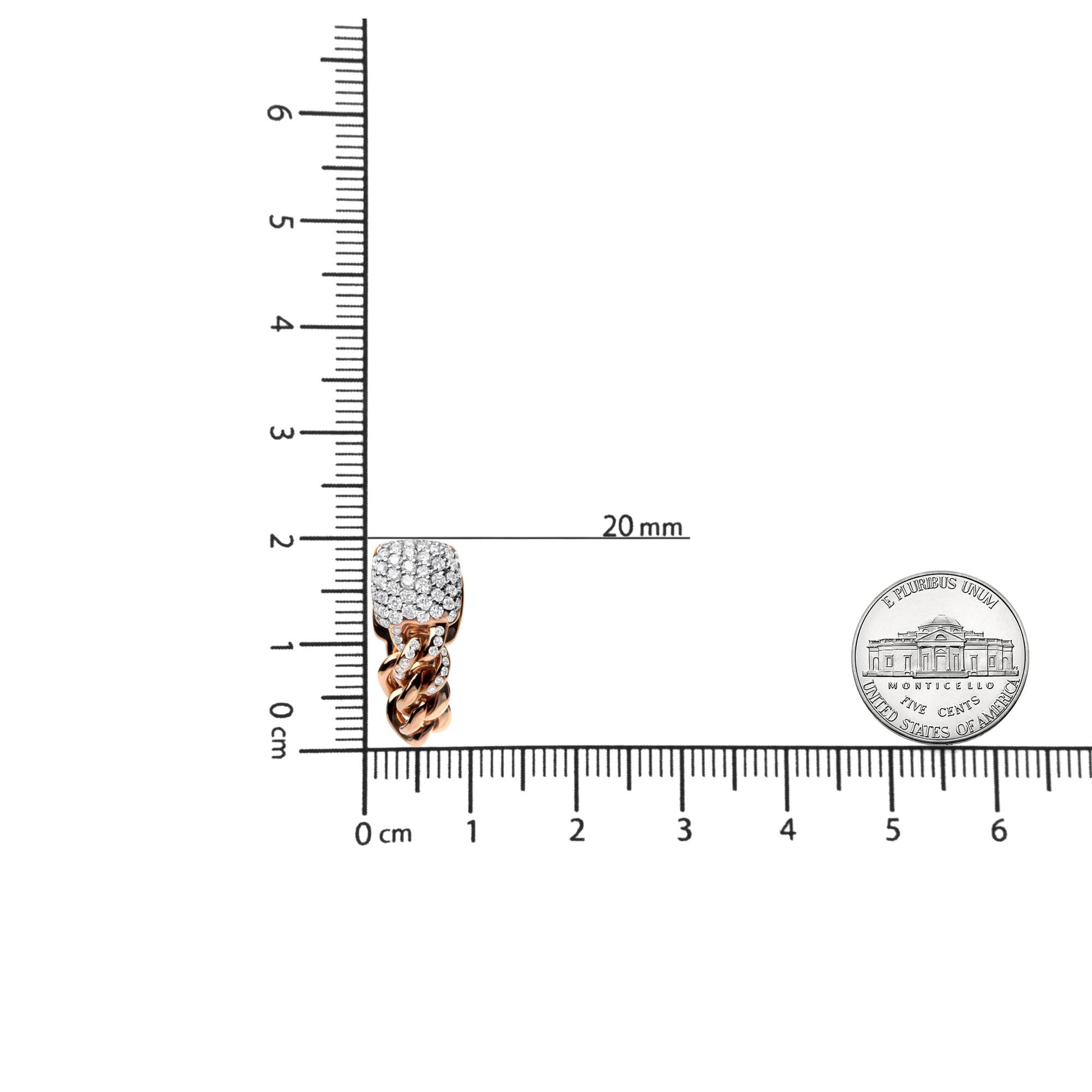 Close-up front view of a rose-colored metal earring with a cushion-shaped top encrusted with white round prong-set gemstones, and a twisted chain design below, placed on a ruler and scale for size reference.