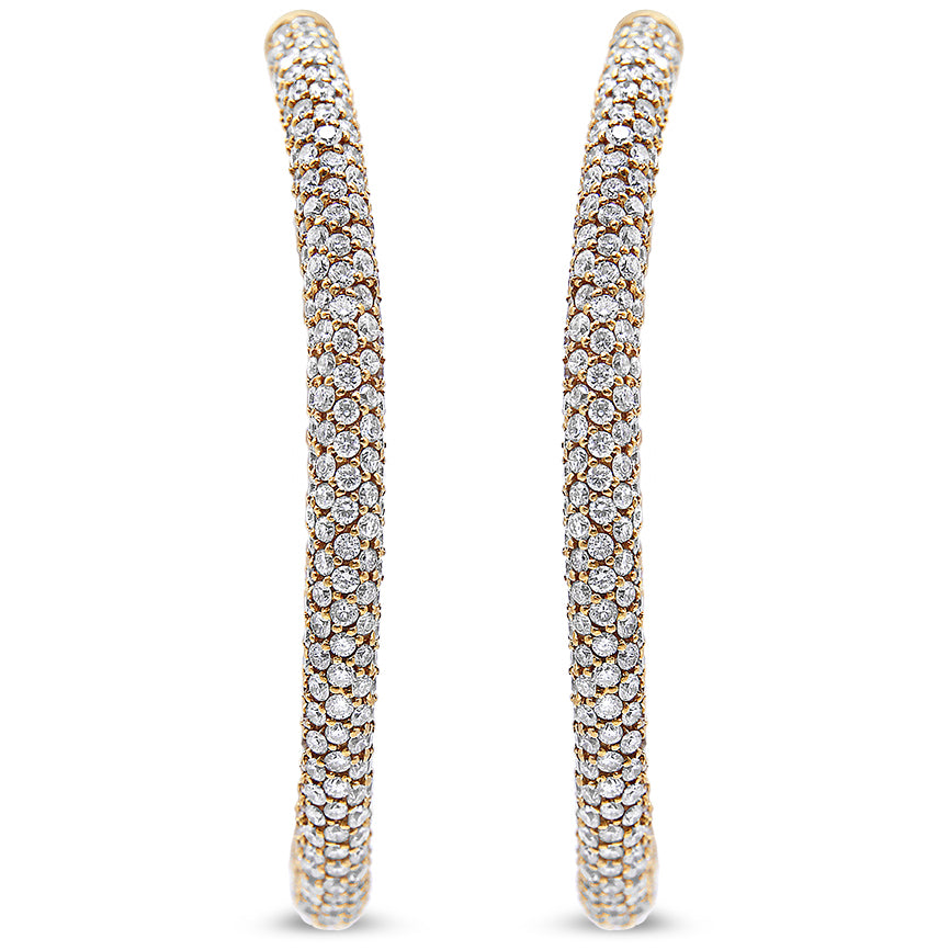 Close-up front view of a pair of rose-colored hoop earrings entirely covered with round white gemstones in pave settings.