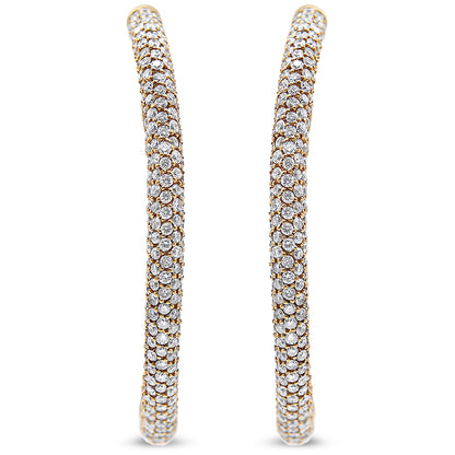 Close-up front view of a pair of rose-colored hoop earrings entirely covered with round white gemstones in pave settings.
