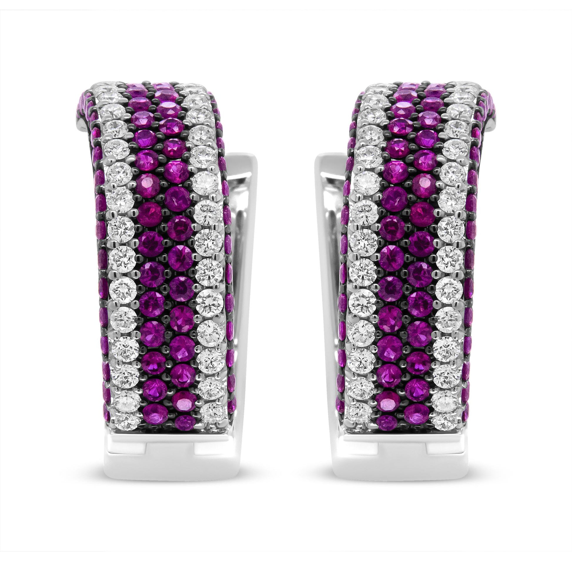 Front view of white metal earrings featuring alternating rows of round red and white gemstones in prong settings.