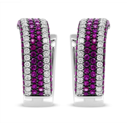 Front view of white metal earrings featuring alternating rows of round red and white gemstones in prong settings.