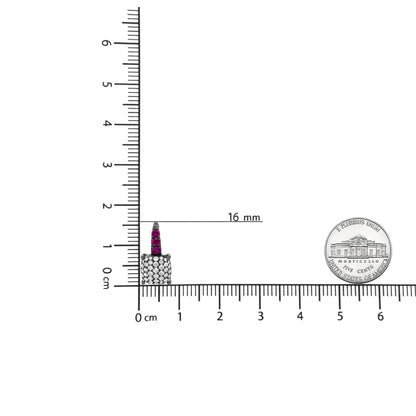 White metal earring with square cluster of white gemstones and row of red gemstones above, shown upright on a ruler and scale for size reference.