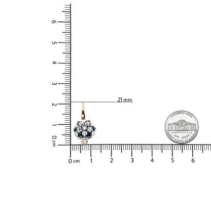 Single earring with white and rose metal, round white gemstones and blue gemstones in prong settings, shown front-facing on a ruler scale for size reference.