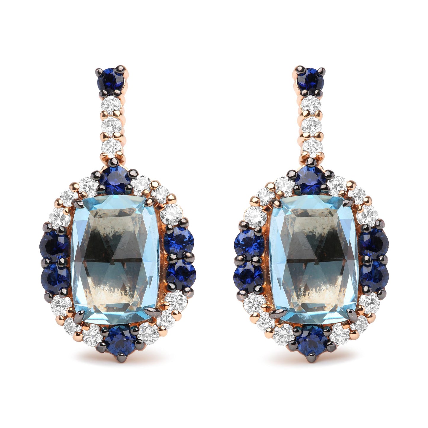 Pair of drop earrings photographed from the front, featuring large cushion-shaped blue gemstones surrounded by round blue and white gemstones, set in white and rose-colored metal.