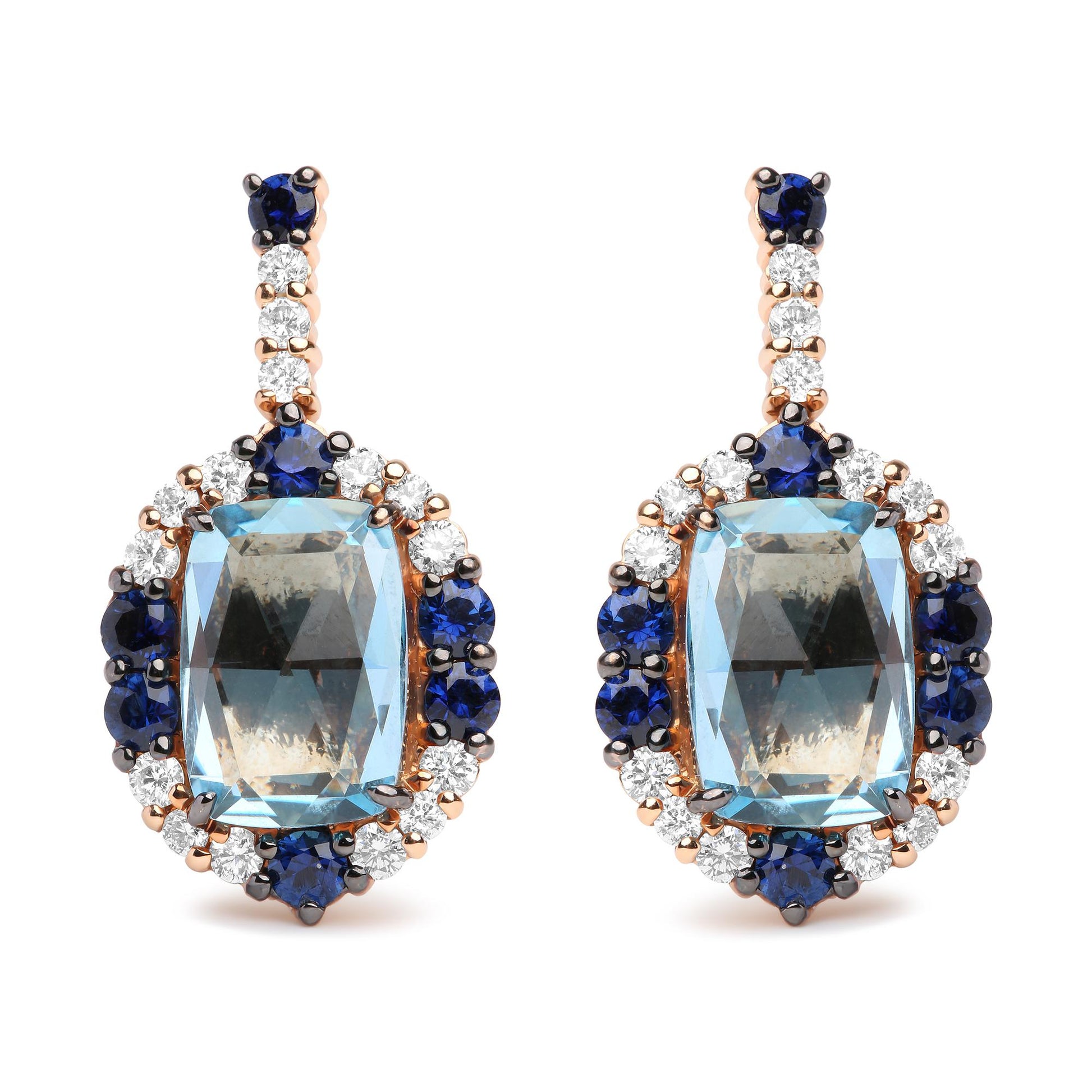 Pair of drop earrings photographed from the front, featuring large cushion-shaped blue gemstones surrounded by round blue and white gemstones, set in white and rose-colored metal.