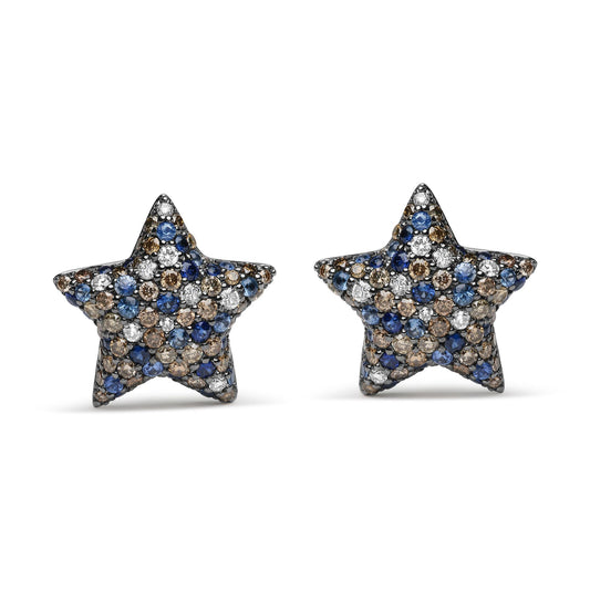 Front-facing shot of star-shaped white metal earrings with pave setting of round red, white, and blue gemstones.