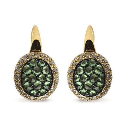 Front-facing close-up of yellow and black metal earrings with round green gemstones in the center and round brown gemstones surrounding them in a pave setting.