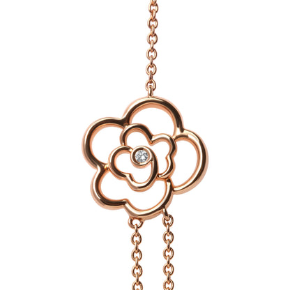 Close-up front view of a rose-colored necklace pendant shaped like an open flower with a round white gemstone in bezel setting at the center, shown against a white background.