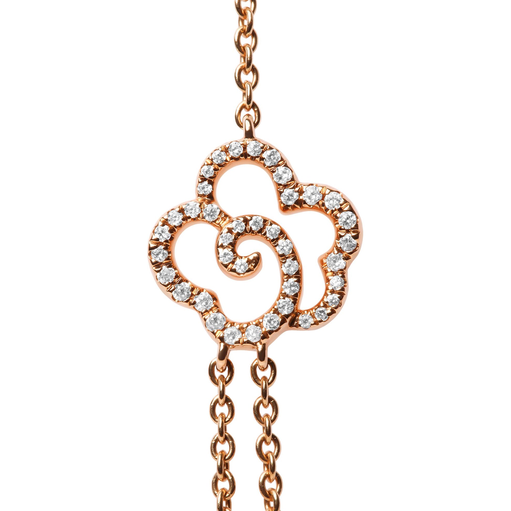 Close-up front view of a rose metal necklace pendant shaped like an abstract flower with round white gemstones in bezel settings along its outline, shown on a white background.