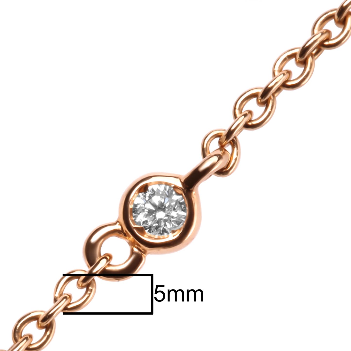 Close-up front angle of a rose metal necklace chain with a round bezel-set white gemstone pendant, shown on a scale with a 5mm reference.