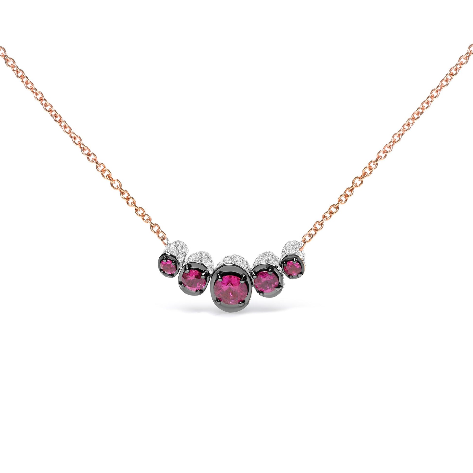 Front view of a rose metal necklace featuring a curved row of round red gemstones in prong settings, accented with small round white gemstones in pave settings.