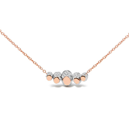 Front-facing close-up of a rose-colored necklace with a central cluster of oval shapes surrounded by white gemstones in pave settings.