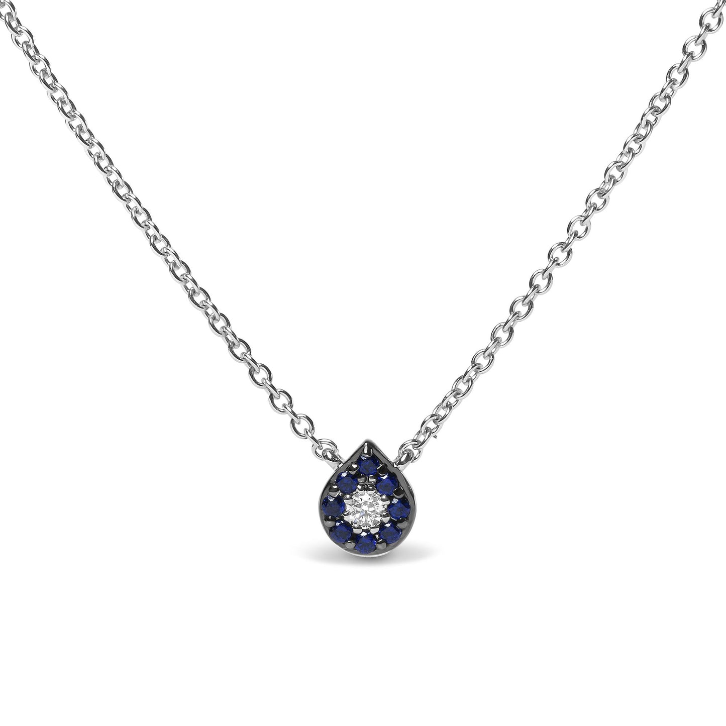 Front view of a white metal necklace with a teardrop-shaped pendant featuring a central round white gemstone surrounded by round blue gemstones in prong settings.