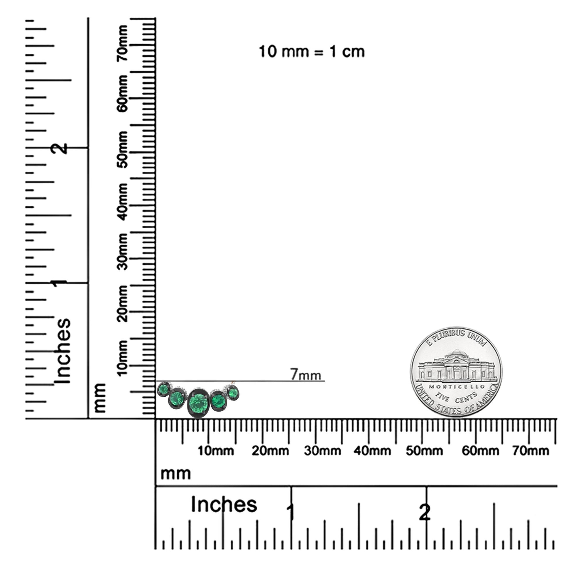 Rose metal necklace with multiple round green gemstones in a curved design, shown on a ruler for size reference, front angle.
