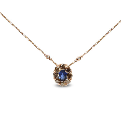Front view of a rose-colored necklace with a central oval blue gemstone surrounded by multiple prong set round brown gemstones, two bezel set round white gemstones on the chain near the pendant.