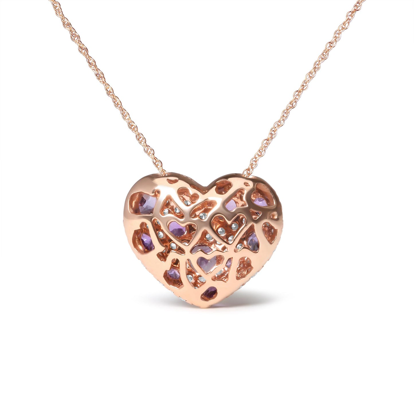 Front angle view of a rose metal heart-shaped necklace pendant featuring a lattice design with embedded white and purple round gemstones in prong settings.