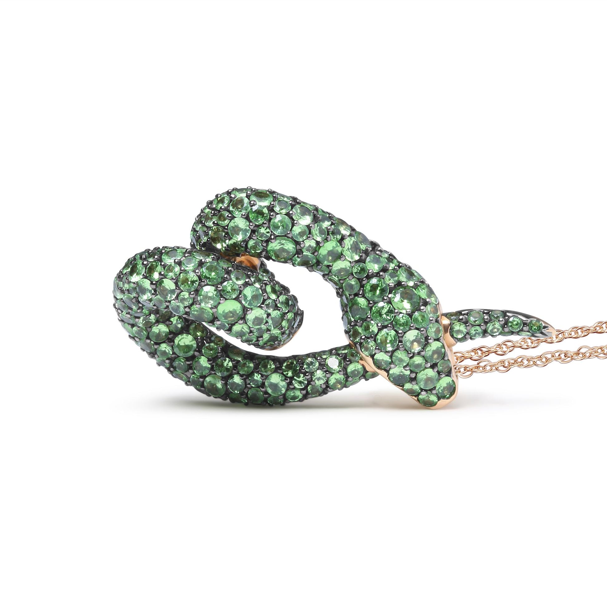 Rose metal snake-shaped necklace with green round gemstones in pave setting, shown from a side angle on a white background.
