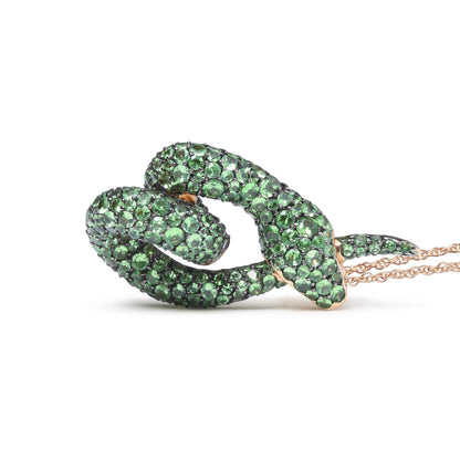 Rose metal snake-shaped necklace with green round gemstones in pave setting, shown from a side angle on a white background.