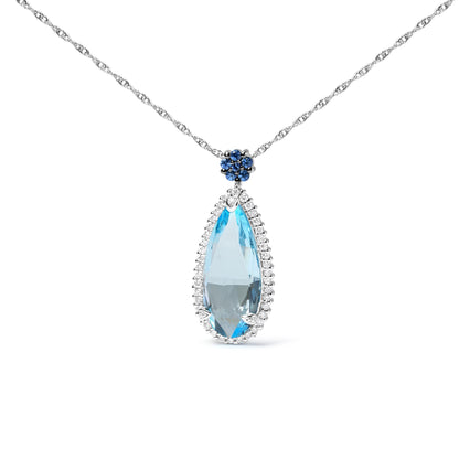 Front angle view of a white metal necklace with a large pear-shaped blue gemstone pendant surrounded by small white gemstones, topped by a cluster of round blue gemstones on a white metal chain.