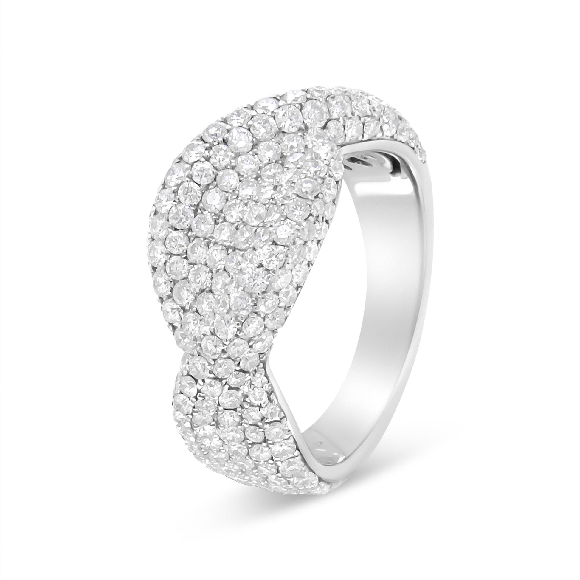 White metal ring with overlapping design, featuring numerous round white gemstones in both pave and prong settings, shown at a three-quarter angle.