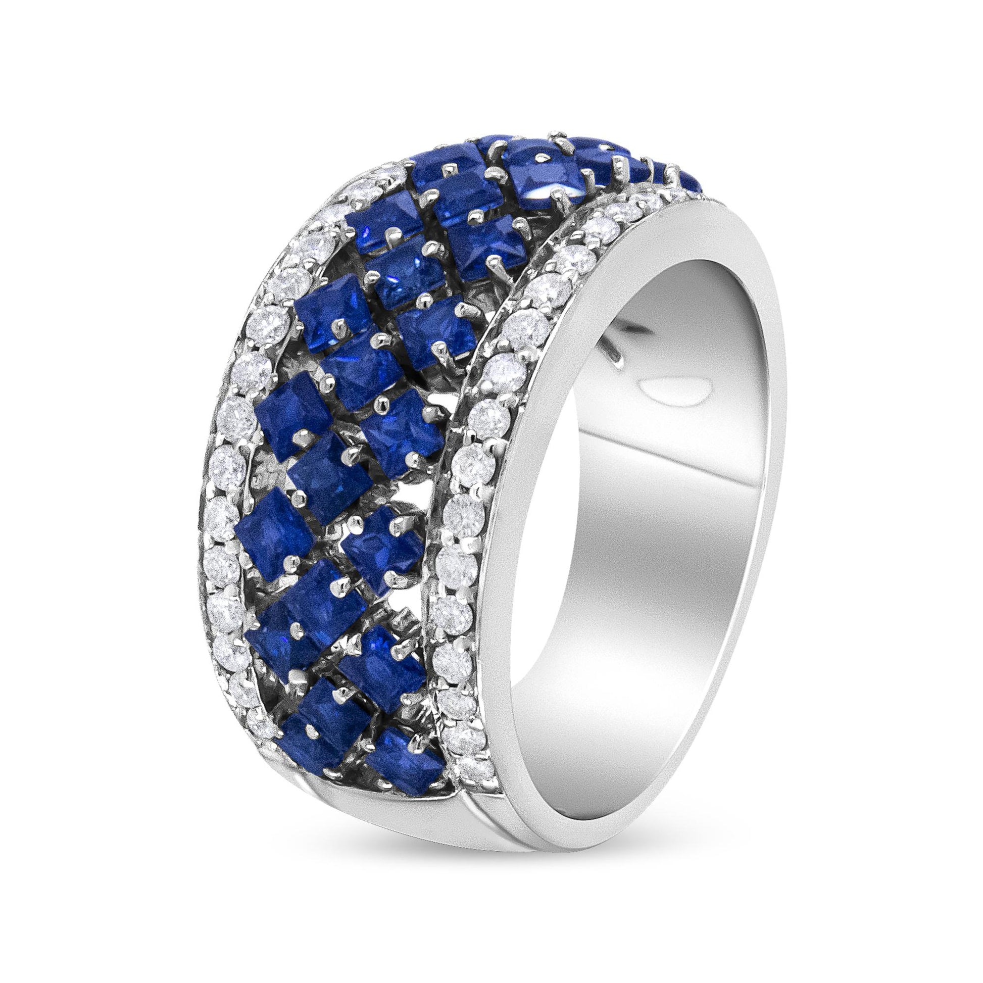 White metal ring with rows of prong-set blue square gemstones in the center flanked by two rows of prong-set round white gemstones, shown at a slight angle.
