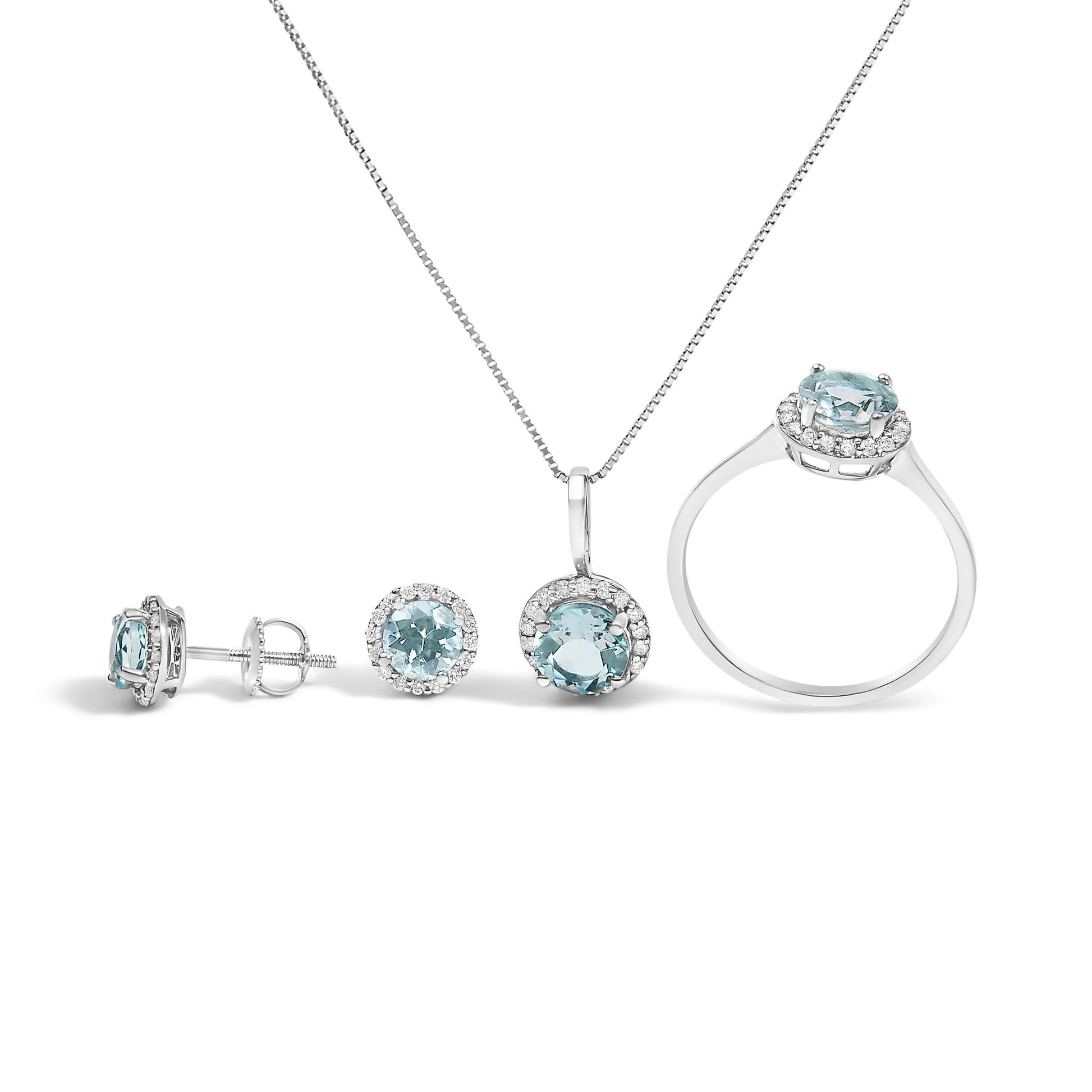 Set of white metal jewelry including a necklace with a pendant, a ring, and stud earrings, each featuring a round blue gemstone surrounded by small white gemstones, shown from a front and side angle on a white background.
