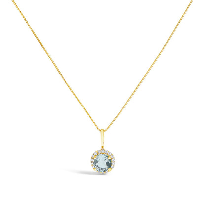 Close-up front view of a yellow metal necklace with a round blue gemstone pendant surrounded by a halo of small white round gemstones.