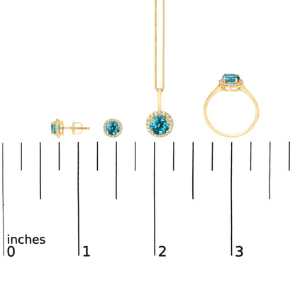 Jewelry set shown on a scale includes a pair of stud earrings, a pendant necklace, and a ring, all featuring round blue gemstones surrounded by small white gemstones, set in yellow metal, shown from front and side angles.