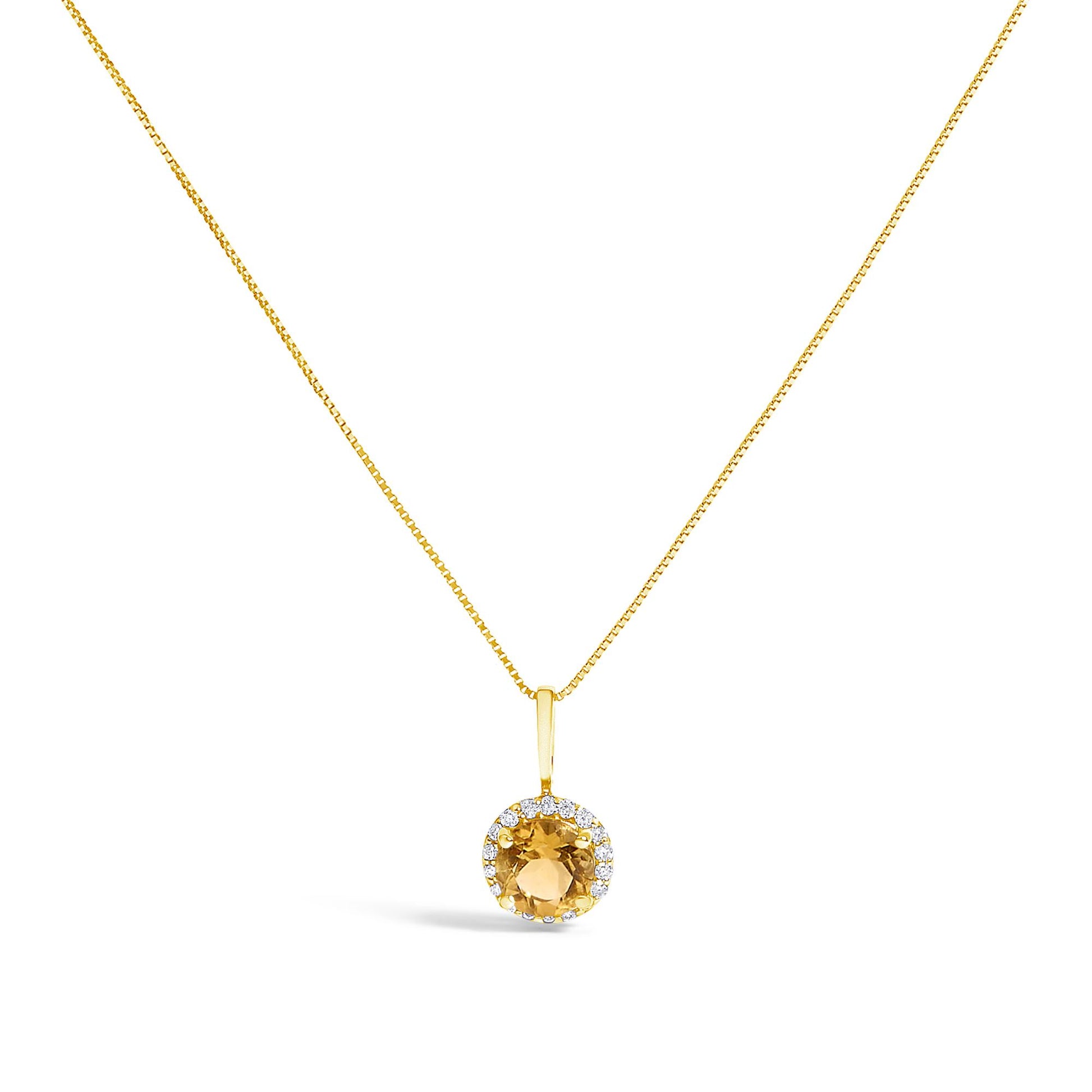 Close-up front view of a yellow metal necklace with a round orange gemstone pendant surrounded by a halo of round white gemstones in shared prong settings, shown on a white background.