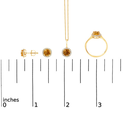 Set of yellow metal jewelry including round orange gemstone stud earrings, a matching pendant on a chain, and a ring shown on a scale from a front and side angle. Each piece is surrounded by small white gemstones in shared prong settings.