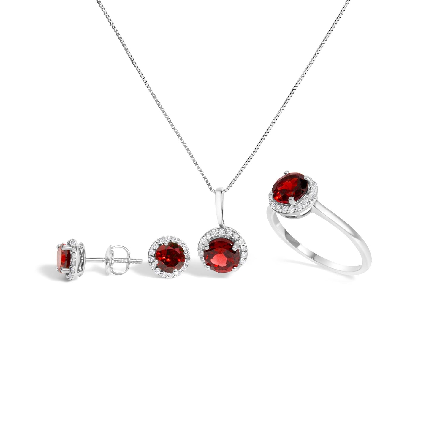 Set of white metal jewelry including a ring, pendant necklace, and stud earrings, each featuring round red gemstones surrounded by a halo of small white gemstones, shown in a front-facing angle on a white background.