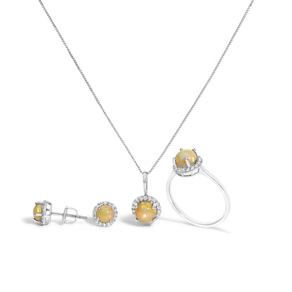 Set of jewelry including a pair of stud earrings, a pendant necklace, and a ring, all featuring round multi-color opal gemstones surrounded by smaller round white gemstones set in white metal, shown in a front-facing shot on a white background.