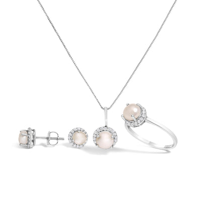 Set of white metal jewelry including a ring, a pendant necklace, and a pair of stud earrings, each featuring a central round light pink gemstone surrounded by a halo of small white gemstones, shown from a front and side angle on a white background.