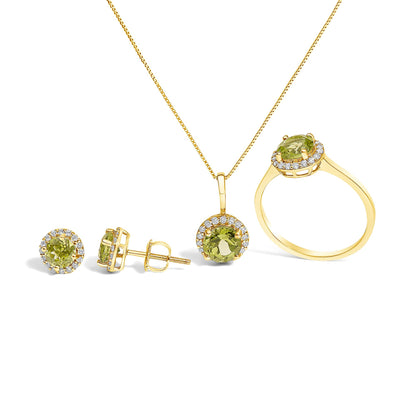 Set of jewelry shown on a white background from a front and side angle, featuring a necklace with a round green gemstone pendant surrounded by small white gemstones, matching round green gemstone stud earrings with white gemstone halos, and a ring with a round green gemstone center encircled by small white gemstones, all in yellow metal.